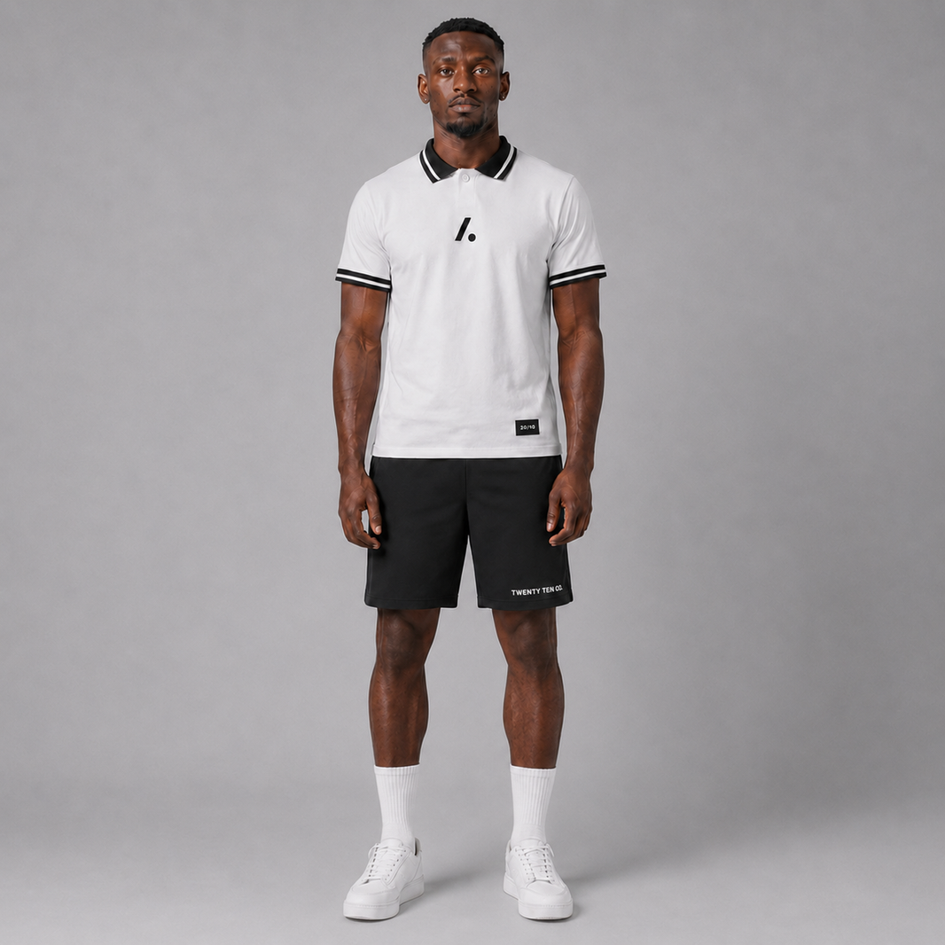 Man wearing a white and black sports outfit with a logo on a gray background