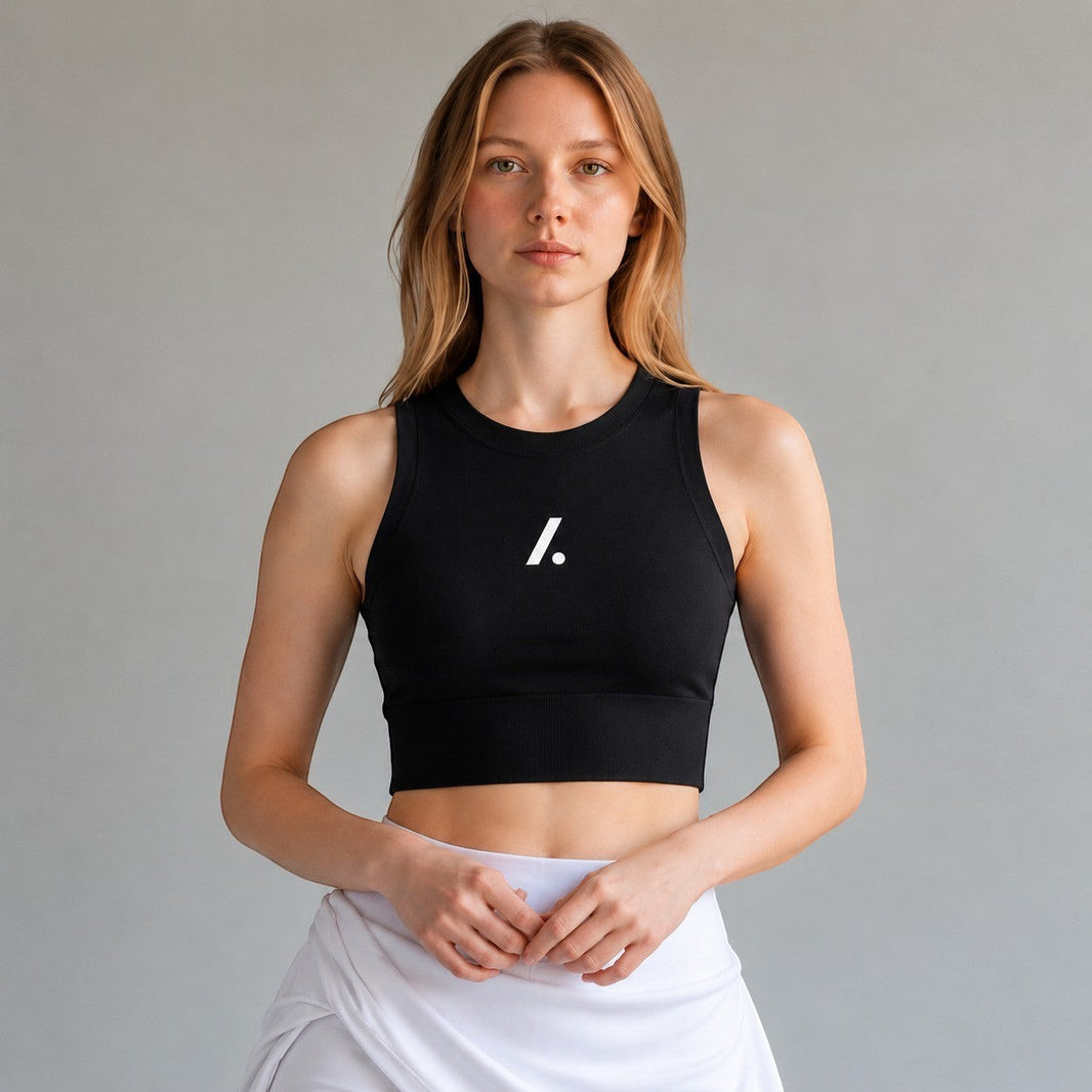 TwentyTenCollective black ribbed athletic tank top with white logo, worn by a model.