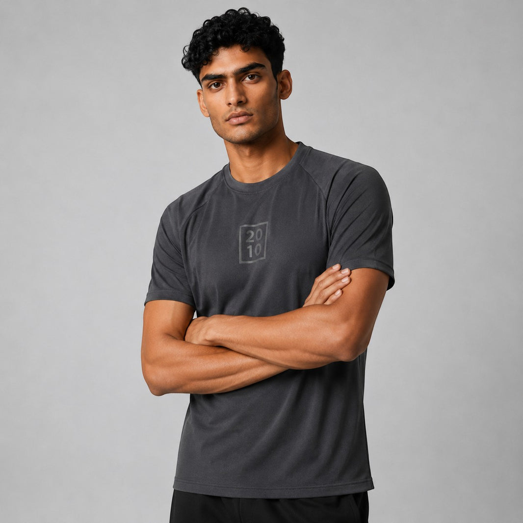 TwentyTenCollective Men's grey athletic t-shirt with raglan sleeves and tonal chest logo. Lightweight, breathable fabric.