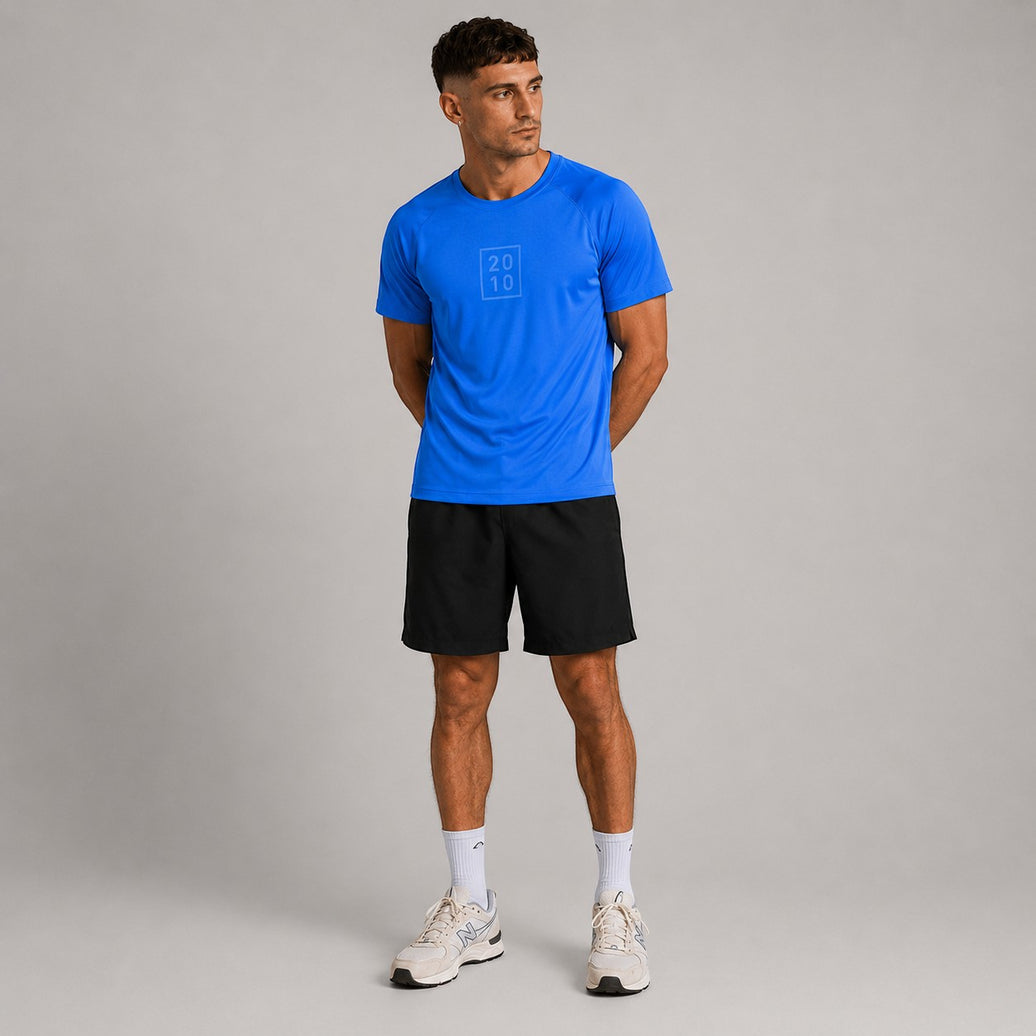 TwentyTenCollective sapphire blue athletic t-shirt with raglan sleeves and tonal chest logo, worn by a man.