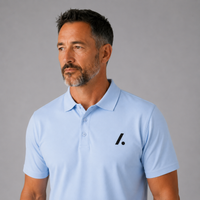 Man wearing a light blue polo shirt with a logo on a gray background