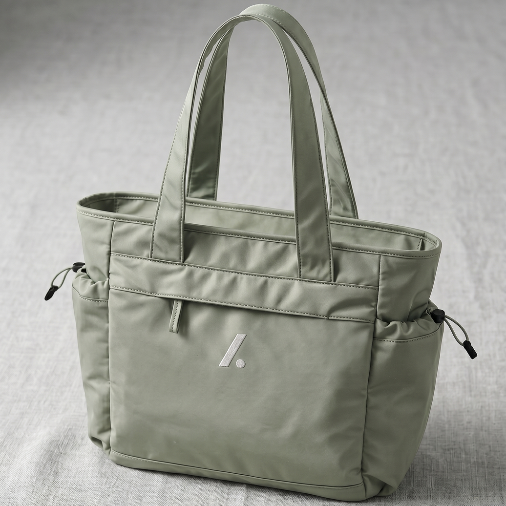 Green tote bag with a visible brand logo on a gray background