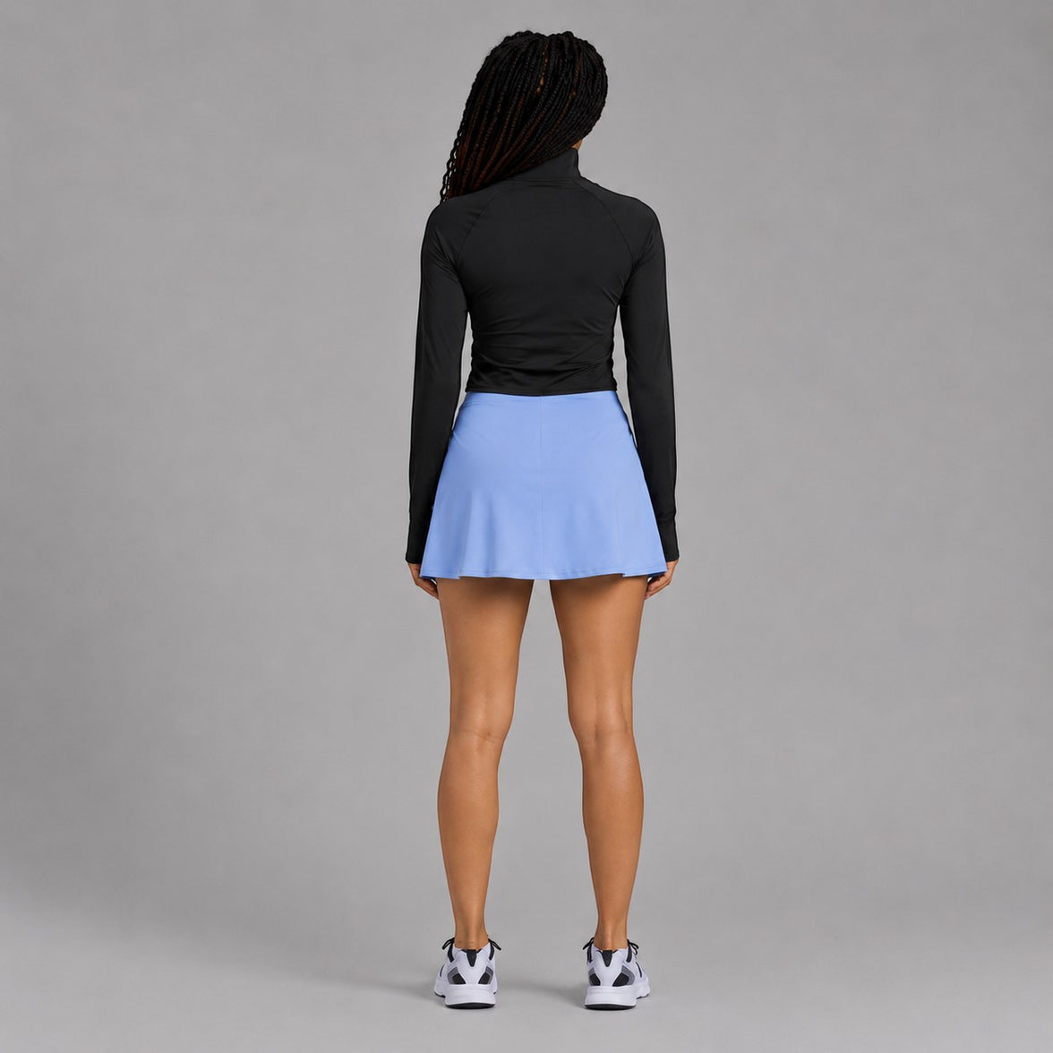 Twenty Ten Co. athletic skort in sky blue with built-in shorts and side pocket. Model from behind.