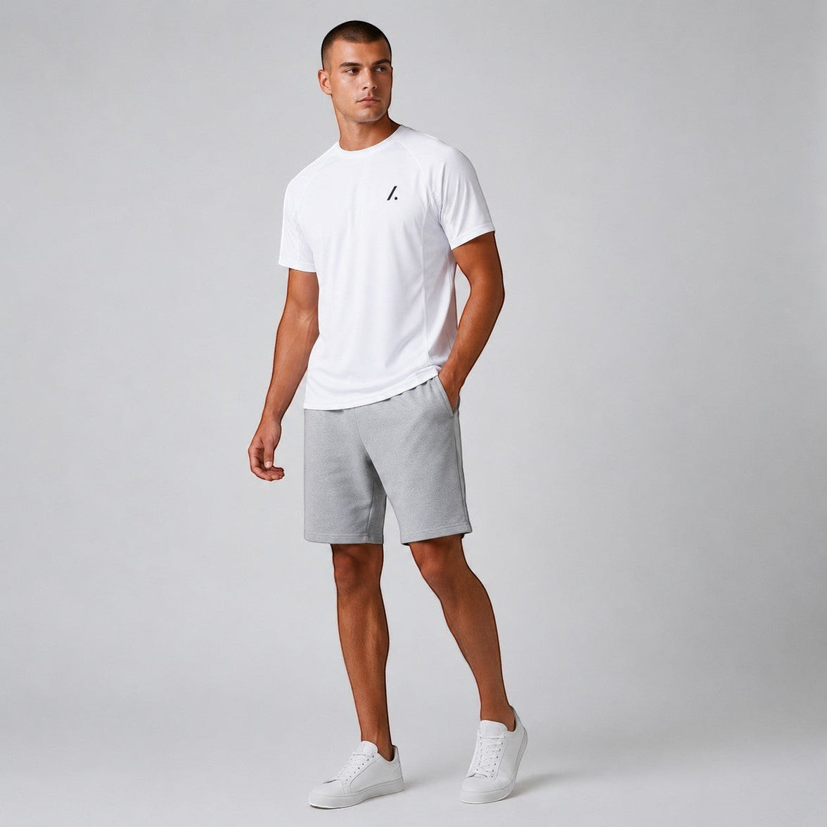 TwentyTenCollective white crew neck t-shirt and grey athletic shorts set on a male model.