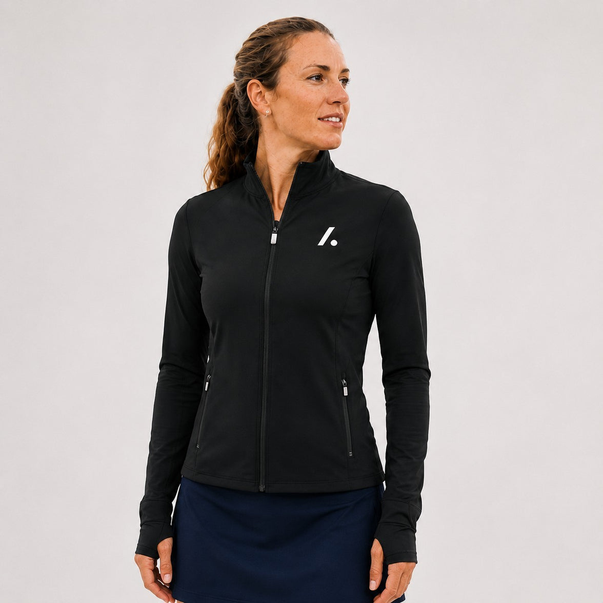TwentyTenCollective black athletic full-zip jacket with mock neck, thumbholes, and zippered pockets.