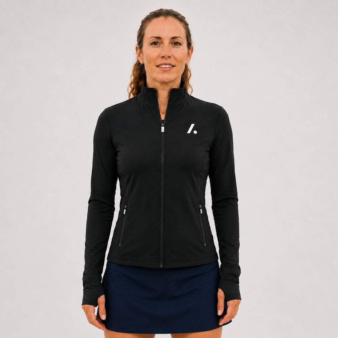 TwentyTenCollective black athletic full-zip jacket with mock neck, thumbholes, and zippered pockets.