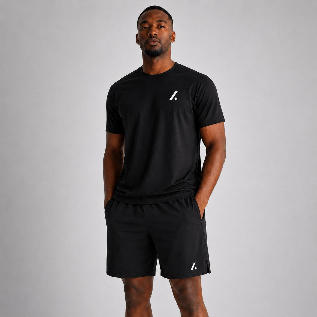 TwentyTenCollective black athletic performance shorts with zipper pockets and side vents. Lightweight, breathable fabric.