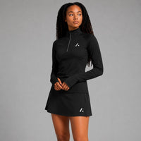 TwentyTenCollective black athletic performance long sleeve half zip top with thumbholes and matching skirt.