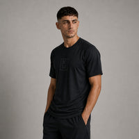 TwentyTenCollective black athletic t-shirt with raglan sleeves and tonal chest logo. Lightweight, breathable fabric for performance.