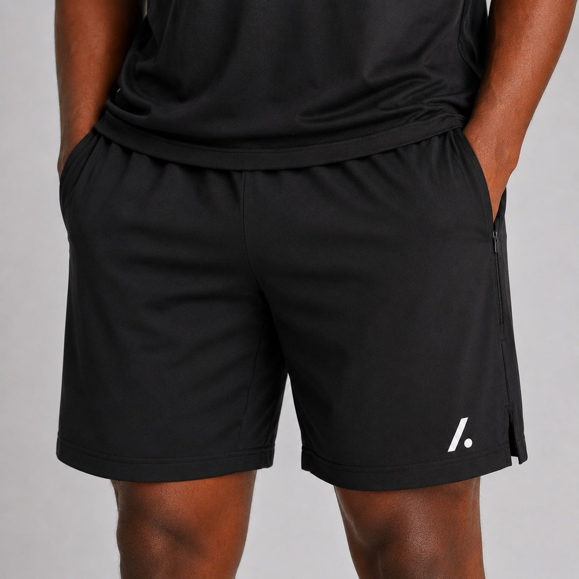 TwentyTenCollective black athletic performance shorts with zipper pockets and side vents. Lightweight, breathable fabric for comfort and movement.