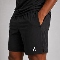 TwentyTenCollective black athletic performance shorts with zipper pockets and side vents. Lightweight, breathable fabric.