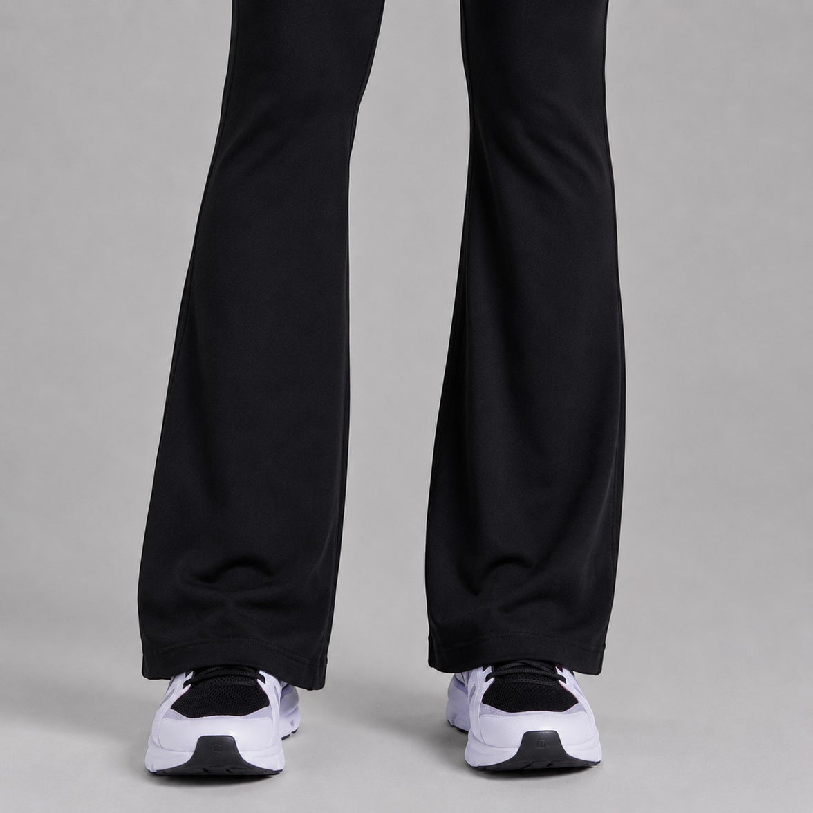 TwentyTenCollective black recycled polyester flared leggings with hidden pocket and white sneakers