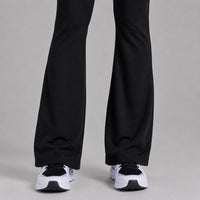 TwentyTenCollective black recycled polyester flared leggings with hidden pocket and white sneakers