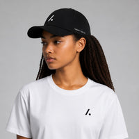 TwentyTenCollective black performance baseball cap with white logo and perforated sides, curved brim.