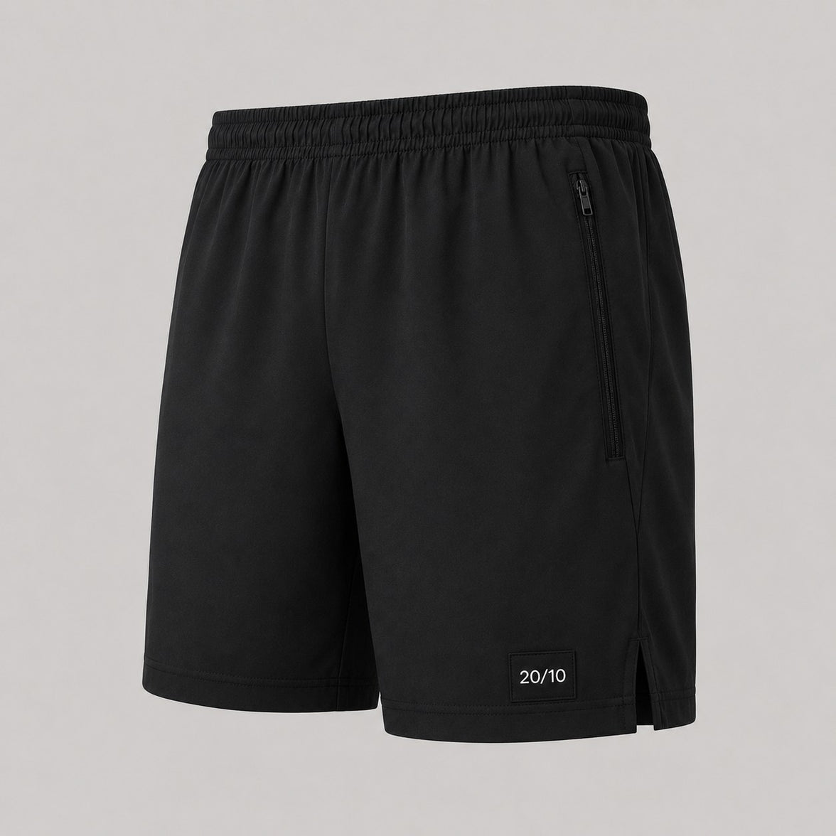 TwentyTenCollective black performance athletic shorts with elastic waistband, zippered pockets, and side vents.