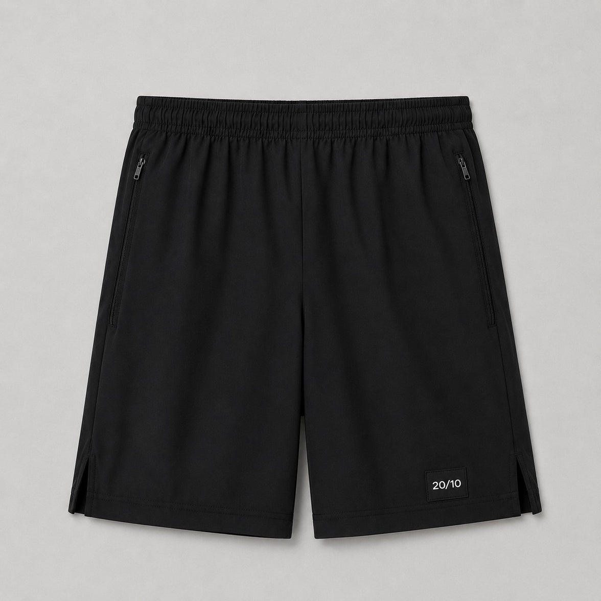 TwentyTenCollective black performance athletic shorts with elastic waistband, zippered pockets, and side vents.