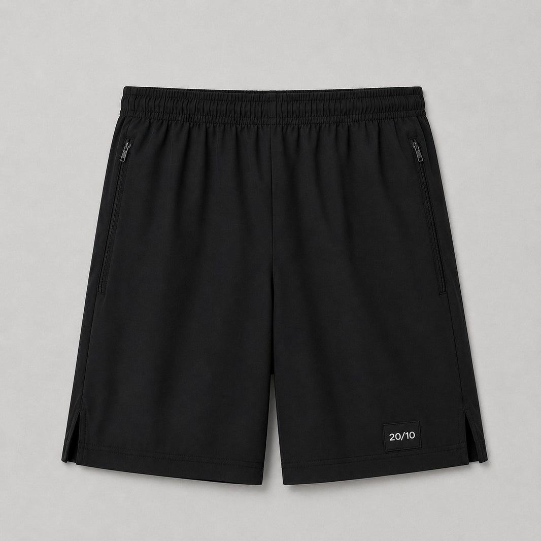TwentyTenCollective black performance athletic shorts with elastic waistband, zippered pockets, and side vents.