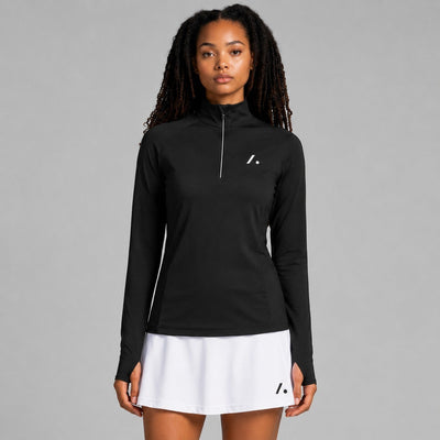 TwentyTenCollective black long-sleeve performance top with quarter zip and thumbholes, worn by a model.