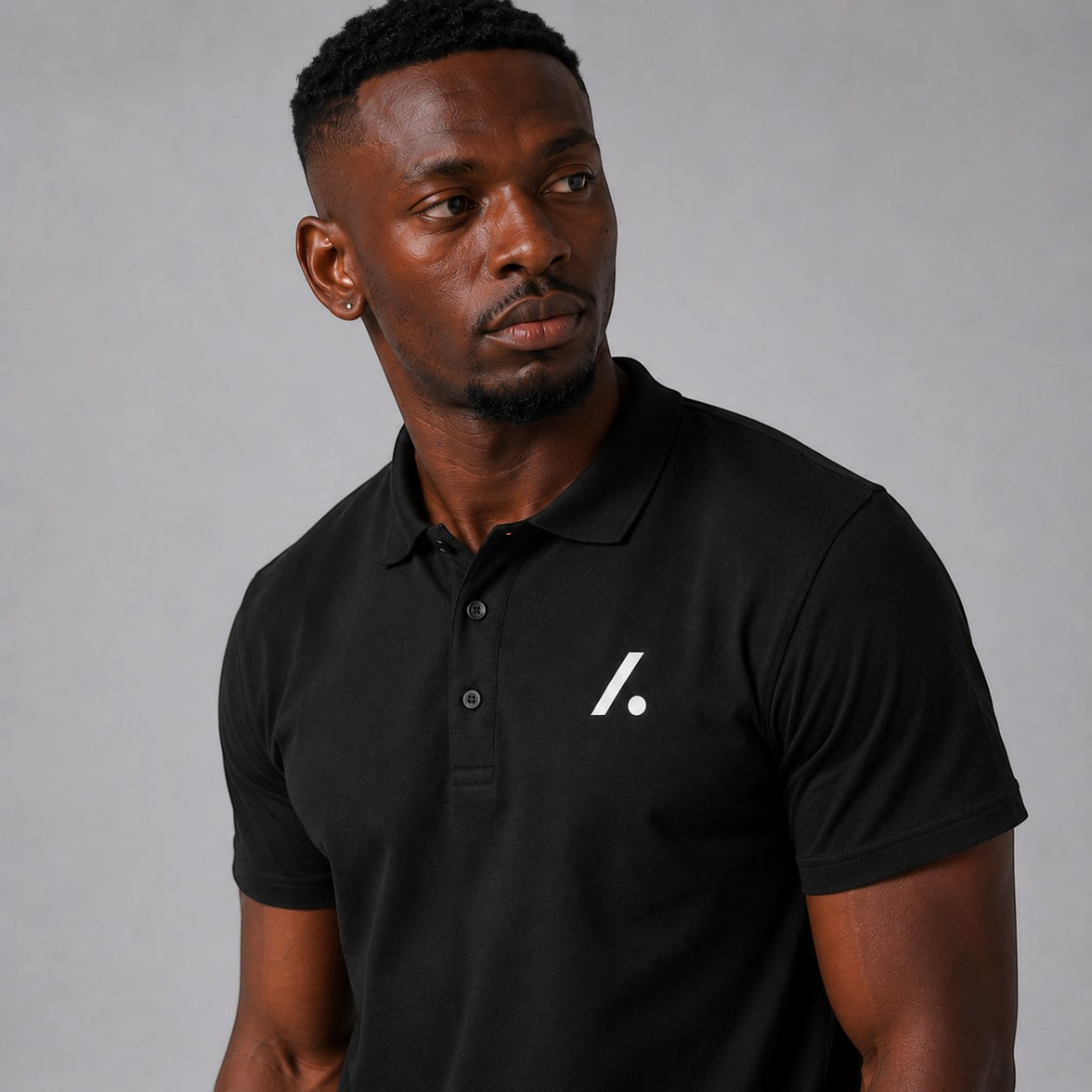 TwentyTenCollective black short sleeve polo shirt with white embroidered logo on chest and ribbed collar.