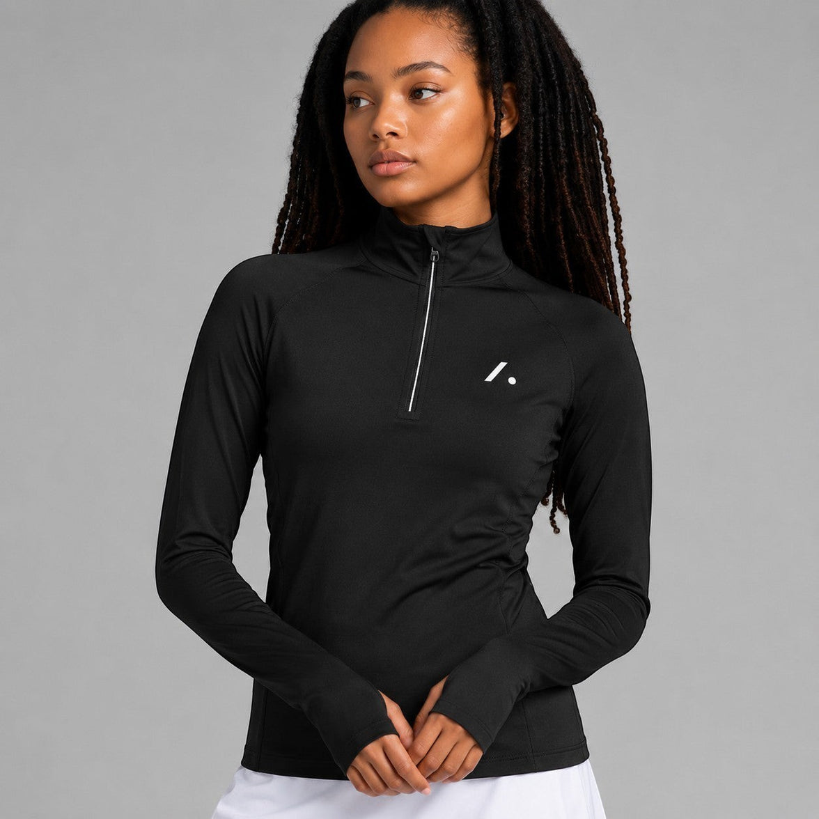 TwentyTenCollective black long-sleeve athletic top with quarter zip and thumbholes. Moisture-wicking fabric.