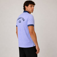 TwentyTenCollective light blue geometric pattern polo shirt with navy collar and cuffs, featuring "TWENTY TEN CO." on back.