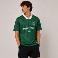 TwentyTenCollective green athletic jersey with white collar and "TWENTY TEN CO." text. Model wears black shorts.