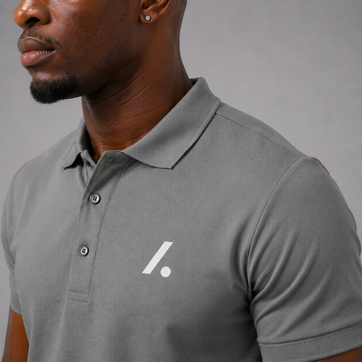 TwentyTenCollective grey performance short sleeve polo shirt with white logo on chest. Classic collar and button placket.