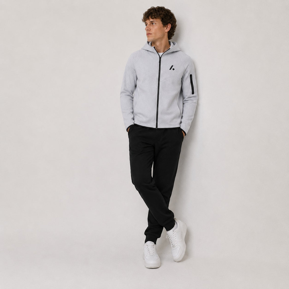 TwentyTenCollective light grey tech fleece full zip hoodie with black logo and zippered sleeve pocket.