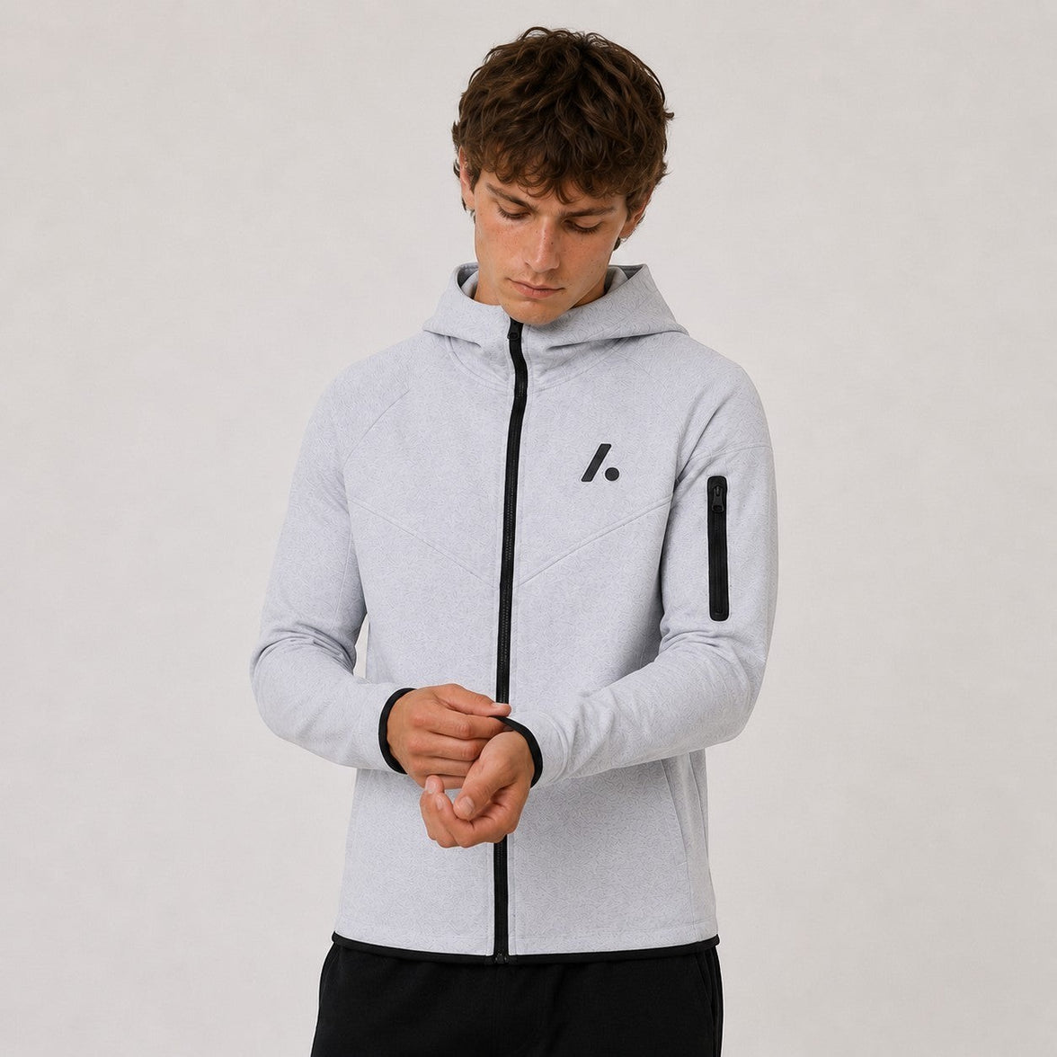 TwentyTenCollective light grey tech fleece full zip hoodie with black logo and zippered sleeve pocket.