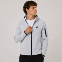 TwentyTenCollective light grey tech fleece full zip hoodie with black logo and zippered sleeve pocket.
