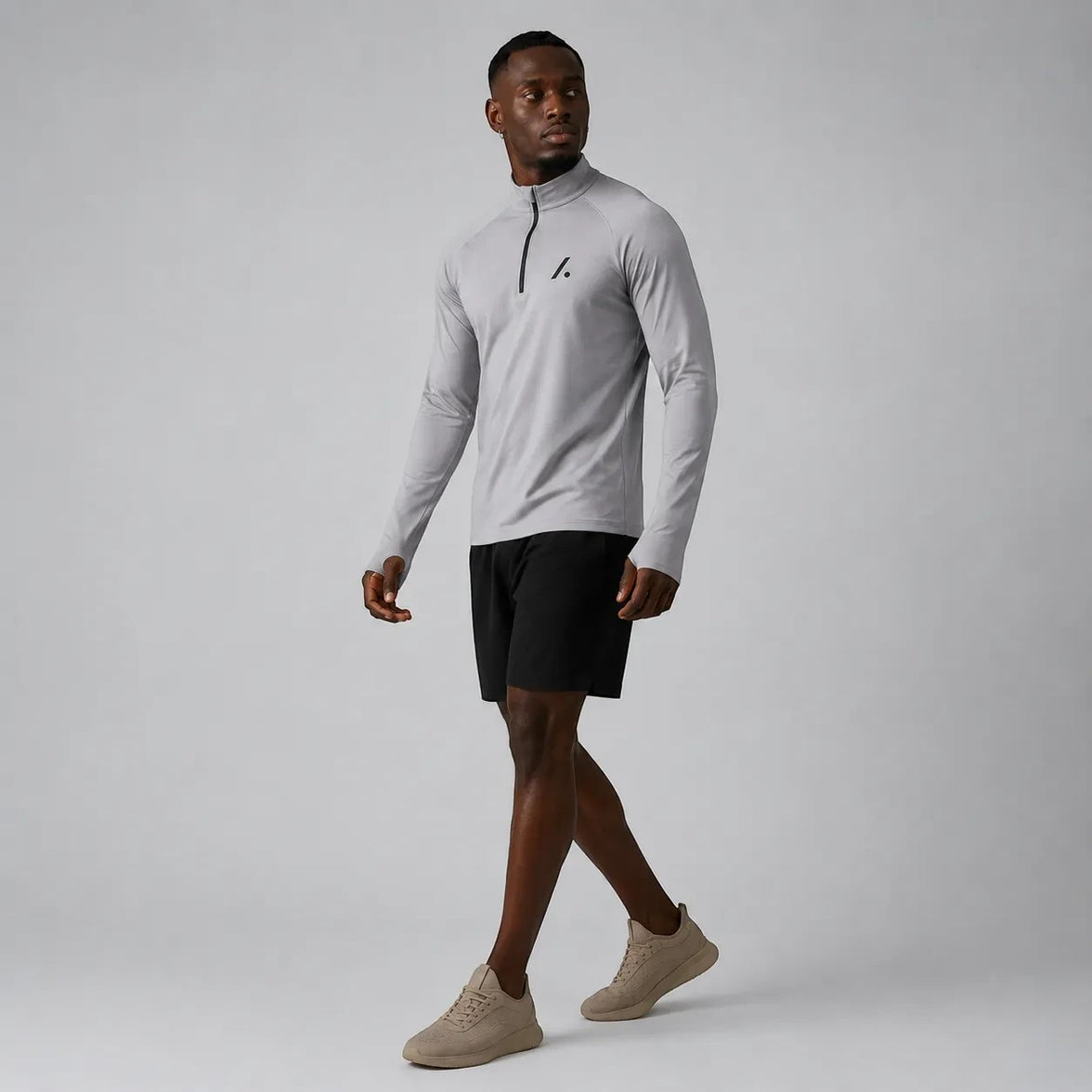 TwentyTenCollective Men's light grey performance quarter zip long sleeve athletic shirt with black logo.