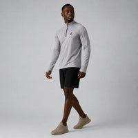 TwentyTenCollective Men's light grey performance quarter zip long sleeve athletic shirt with black logo.