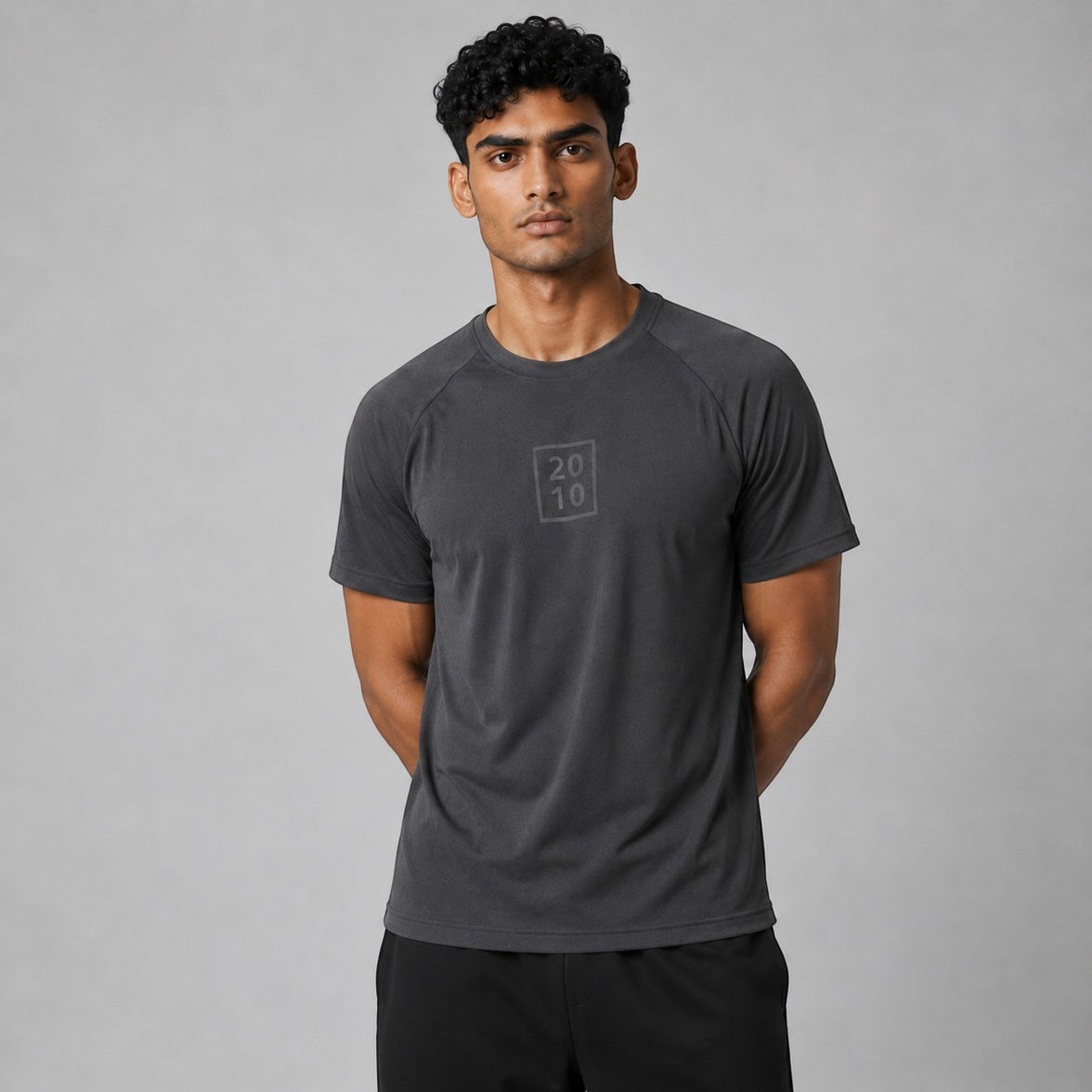 TwentyTenCollective men's dark grey athletic t-shirt with raglan sleeves and tonal chest logo. Lightweight, breathable fabric for performance.