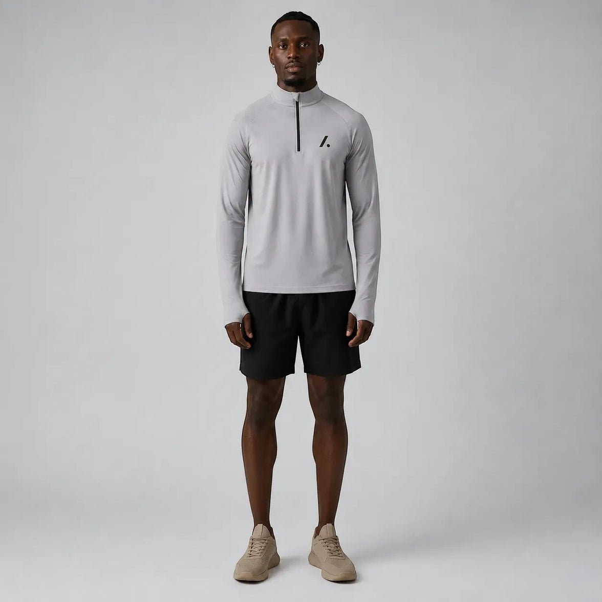 TwentyTenCollective Men's light grey quarter zip long sleeve athletic shirt with black logo detail.