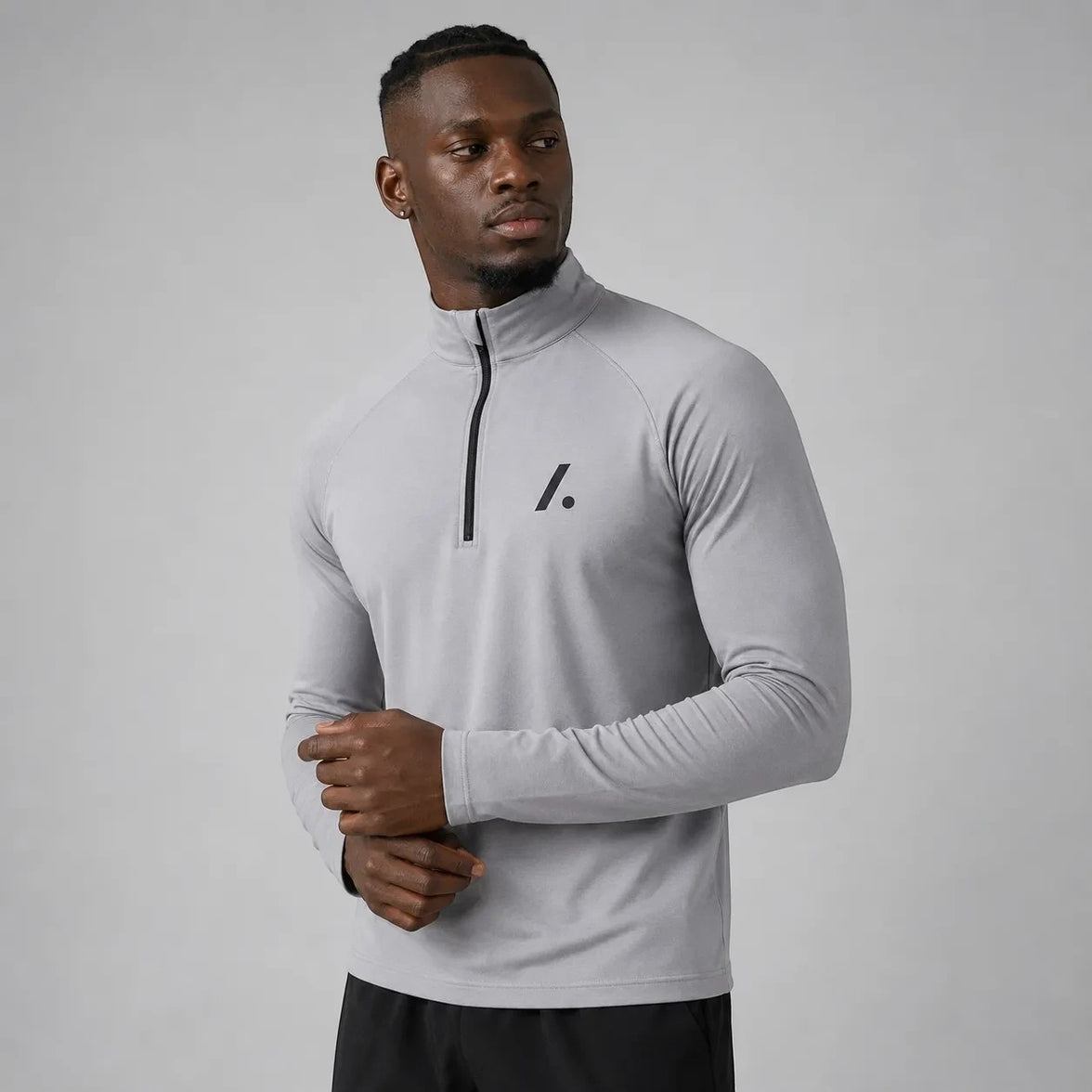 TwentyTenCollective men's light grey long sleeve performance quarter zip athletic shirt with black logo.