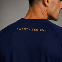 TwentyTenCollective navy athletic t-shirt with gold foil logo on back. Crew neck, raglan sleeves.