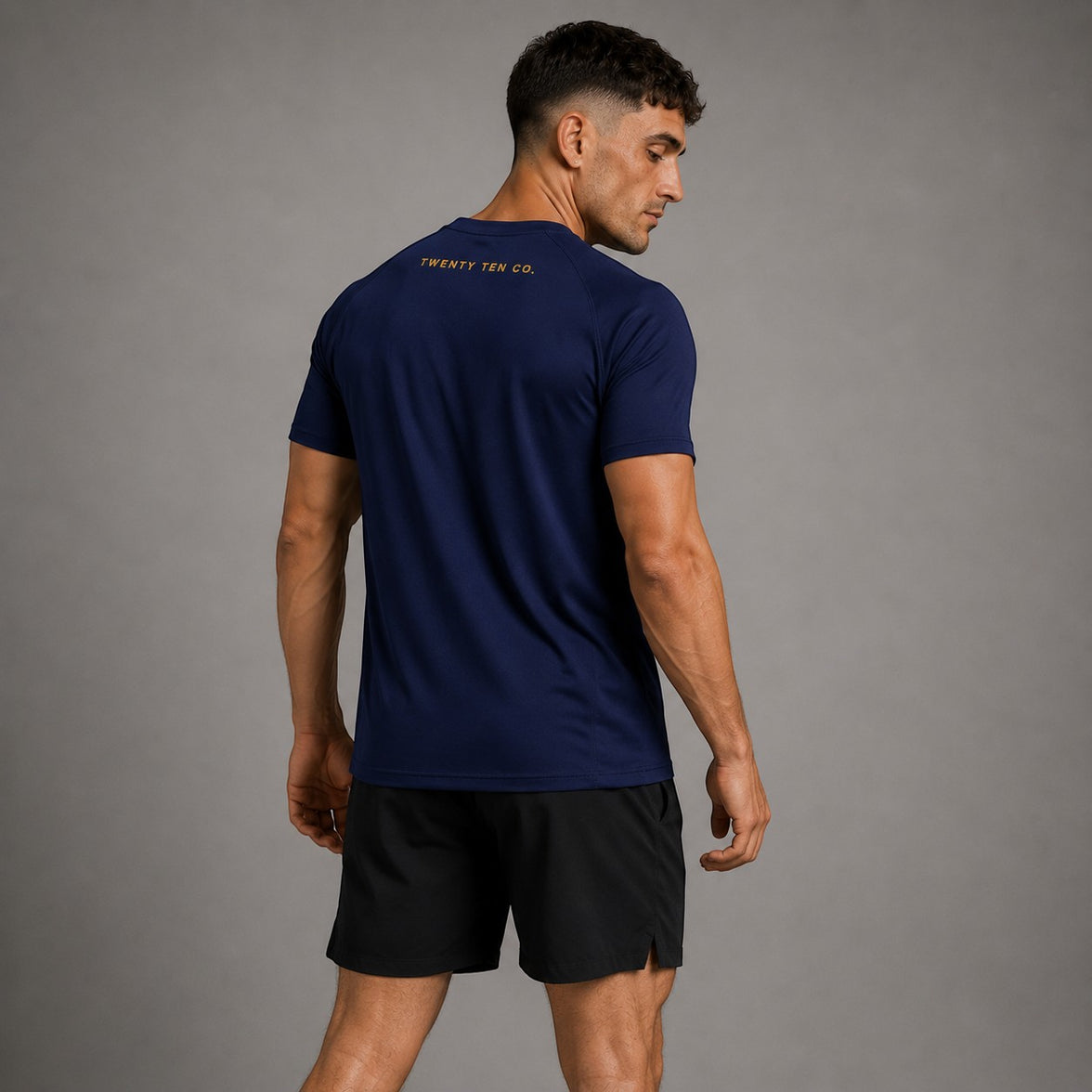 TwentyTenCollective navy performance t-shirt with gold foil logo on back, raglan sleeves, crew neck.