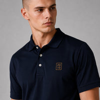 TwentyTenCollective navy blue short sleeve polo shirt with embroidered emblem on chest. Classic fit, breathable fabric.