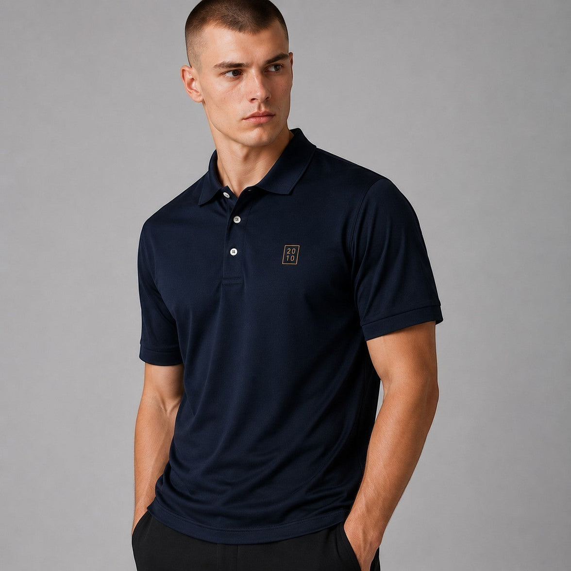 TwentyTenCollective classic navy blue short sleeve polo shirt with embroidered emblem on chest. Model is wearing a size M.