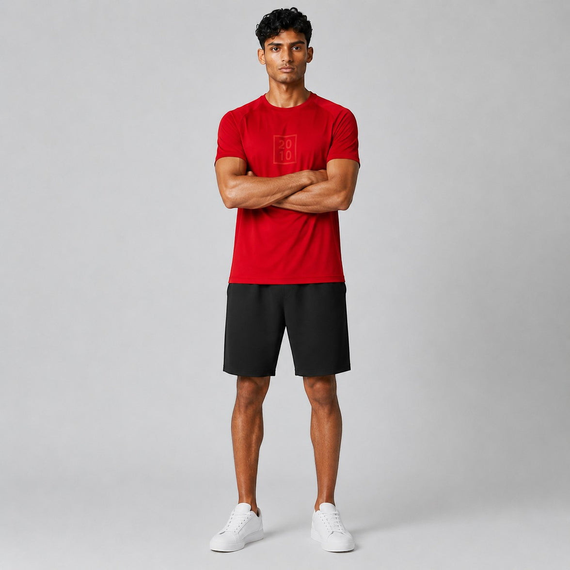 TwentyTenCollective men's red athletic t-shirt with raglan sleeves and tonal chest logo, paired with black shorts.
