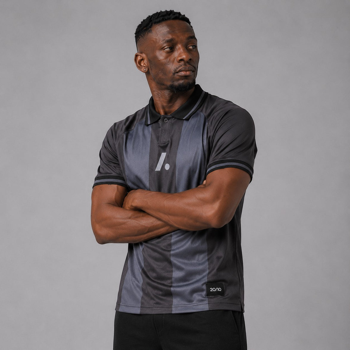 TwentyTenCollective charcoal and dark grey striped athletic polo shirt with a two-button placket and reflective logo.