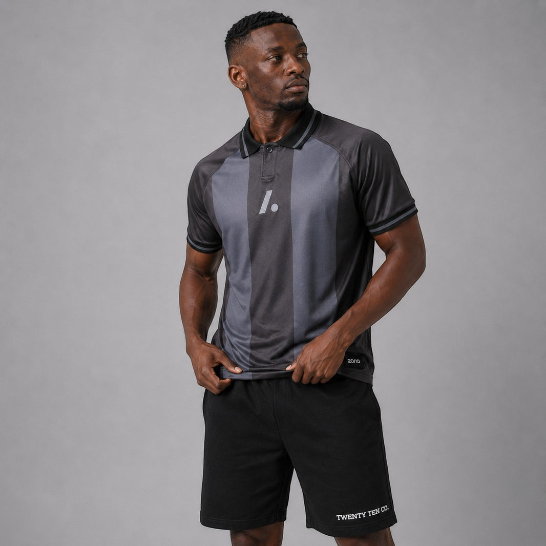 TwentyTenCollective charcoal and dark grey striped athletic polo shirt with two-button placket and reflective logo.