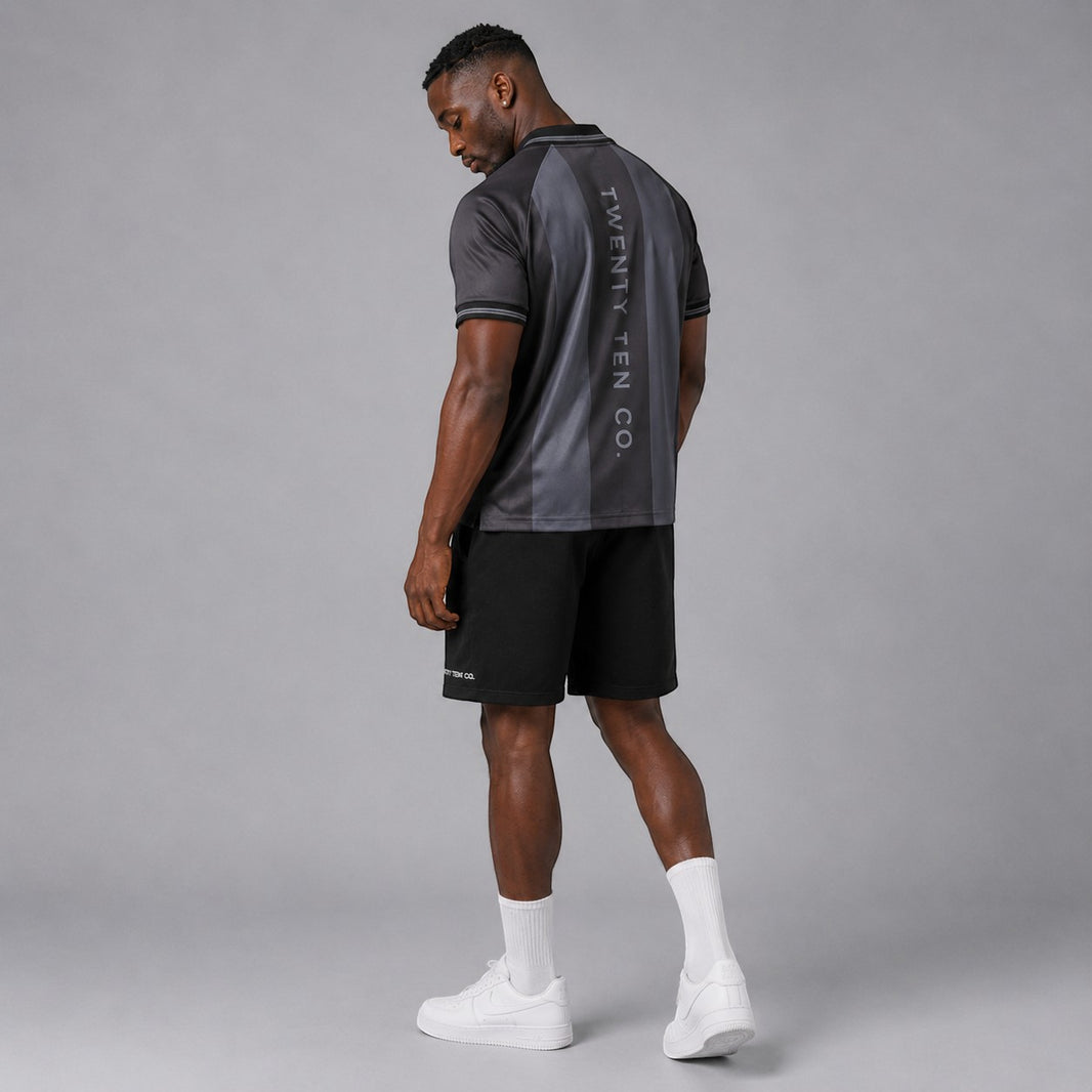 TwentyTenCollective men's charcoal and dark grey striped athletic polo shirt with reflective logo and '2010' detail.