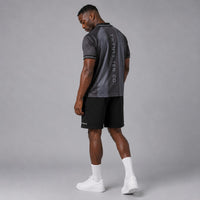 TwentyTenCollective men's charcoal and dark grey striped athletic polo shirt with reflective logo and '2010' detail.
