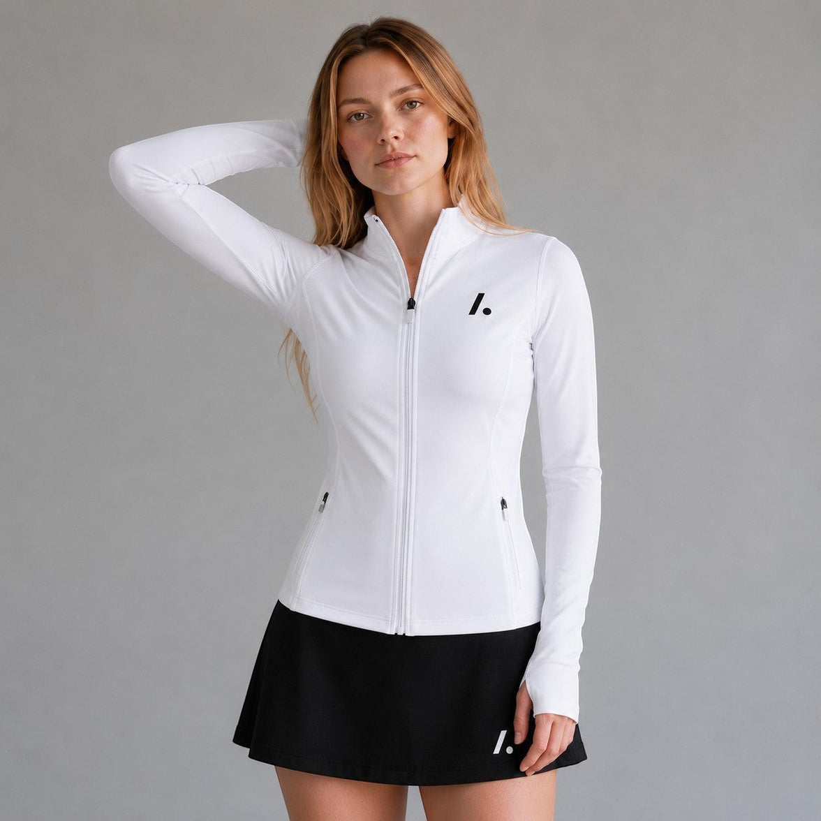 TwentyTenCollective white athletic full zip jacket with mock neck, thumbholes, and zippered pockets. Model wears size S.