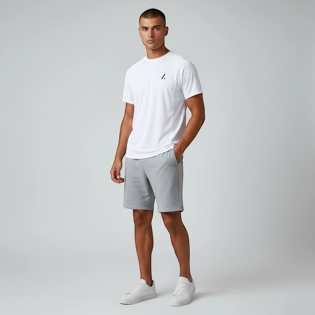 TwentyTenCollective white crew neck t-shirt with subtle logo and grey athletic shorts set for men.