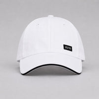 TwentyTenCollective white baseball cap with black trim and a black "20/10" logo patch.