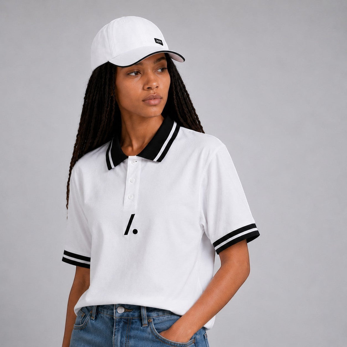 TwentyTenCollective white cotton blend polo shirt with black striped collar and cuffs, and a minimalist logo accent.