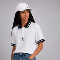 TwentyTenCollective white cotton blend polo shirt with black striped collar and cuffs, and a minimalist logo accent.