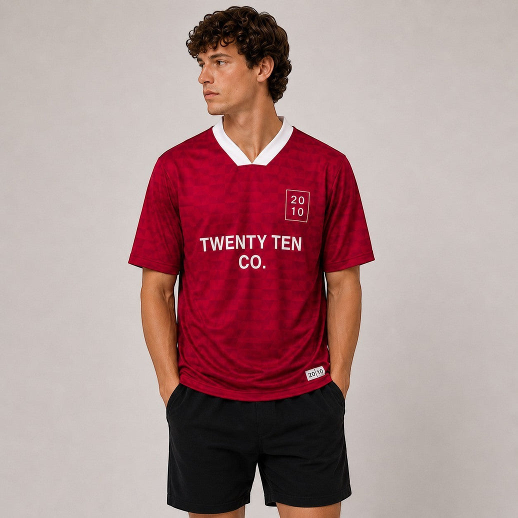 TwentyTenCo. Athletic Short Sleeve Jersey in red with geometric pattern, white crew neck, and contrasting trim.